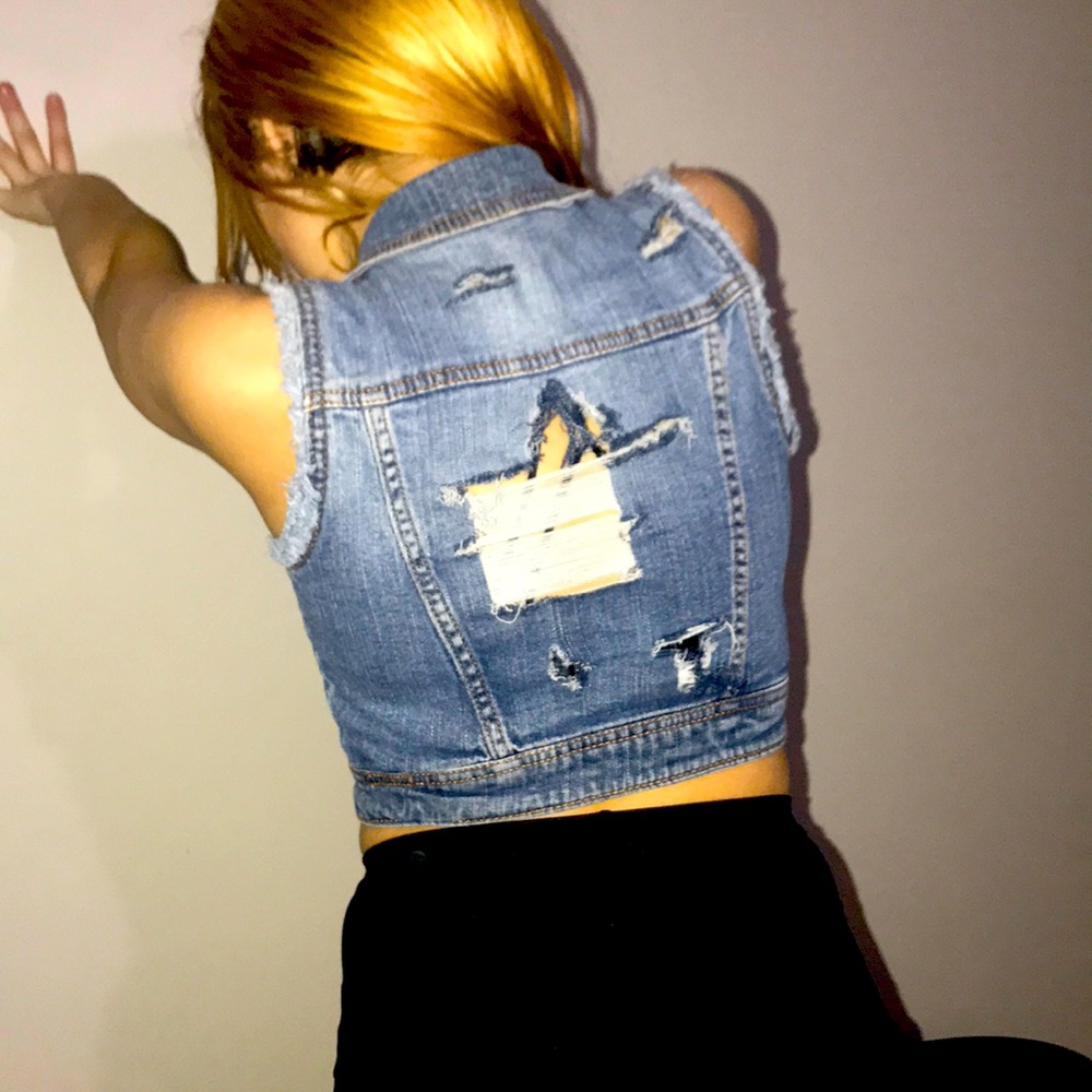 No sleeve Jean jacket ripped in the back and front